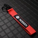 Nissan Set Red Keychain Metal Key Ring with Black Carbon Fiber Look Seat Belt Covers